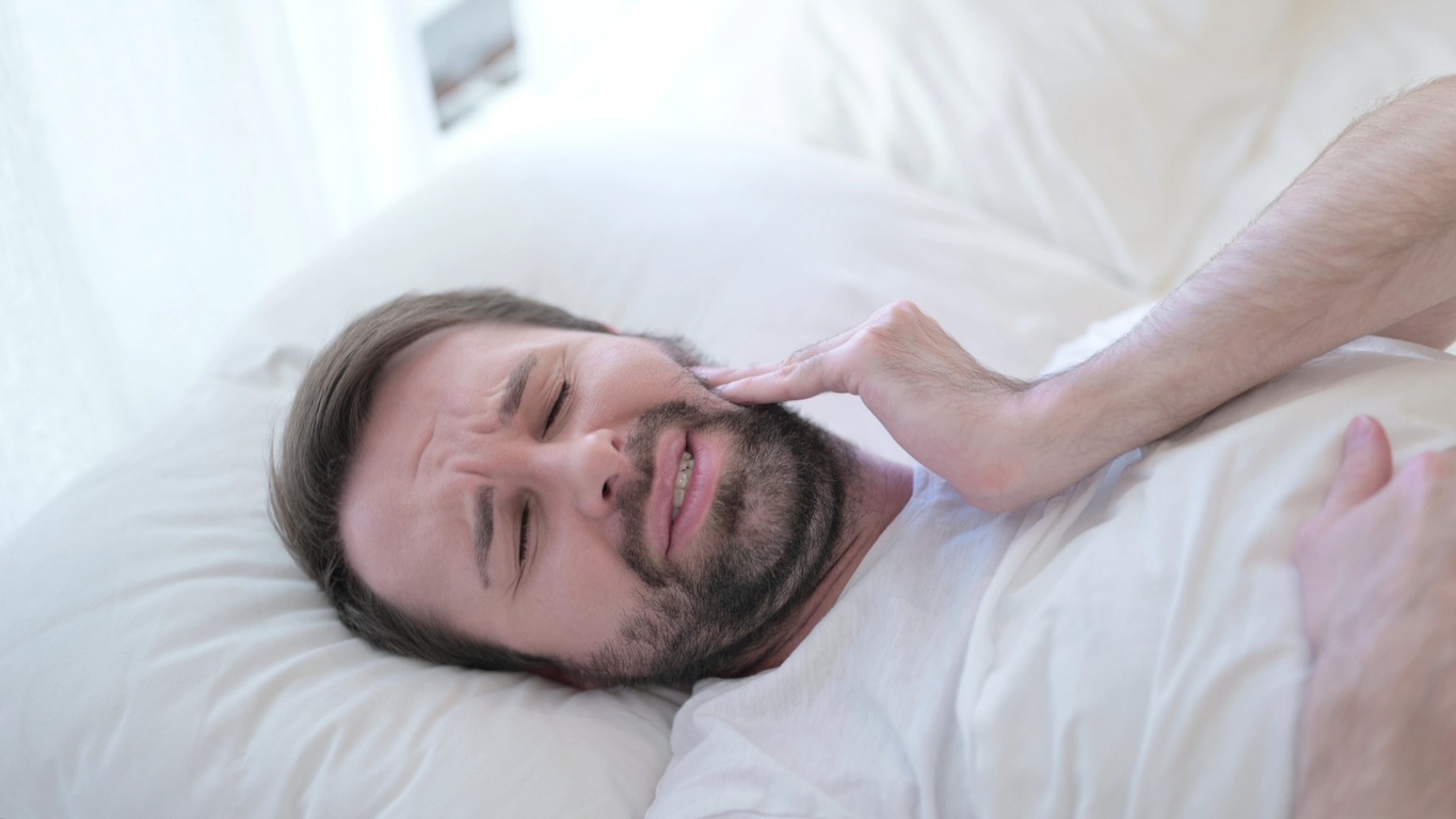 man can’t sleep due to toothache