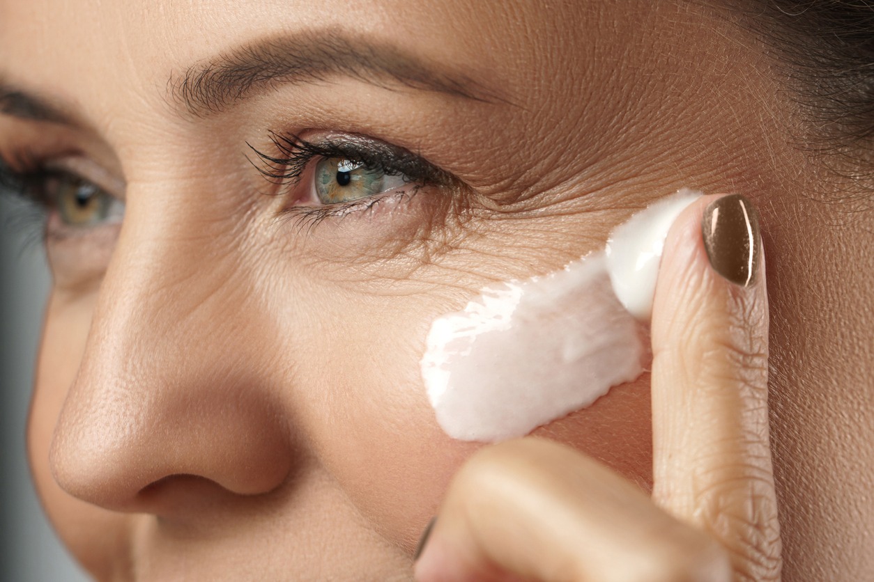 woman applying anti-aging moisturizer on her face