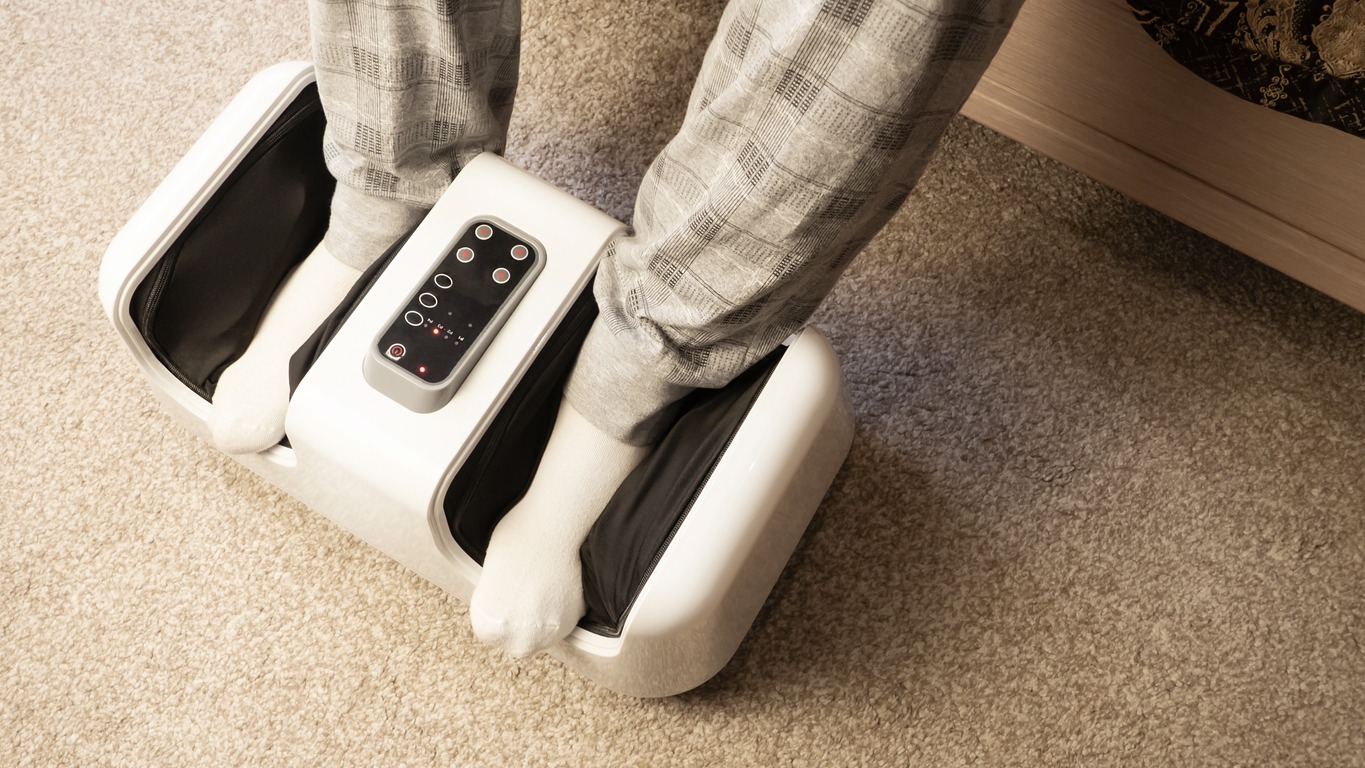 person using a foot massager