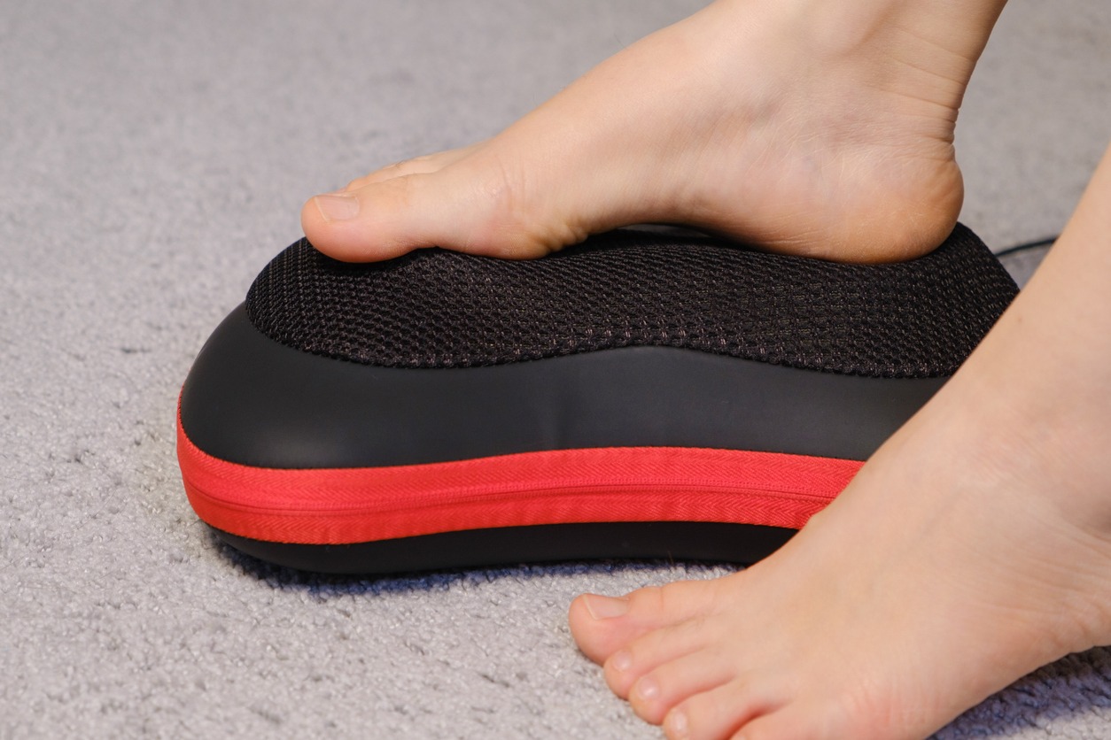person using an electric foot massager