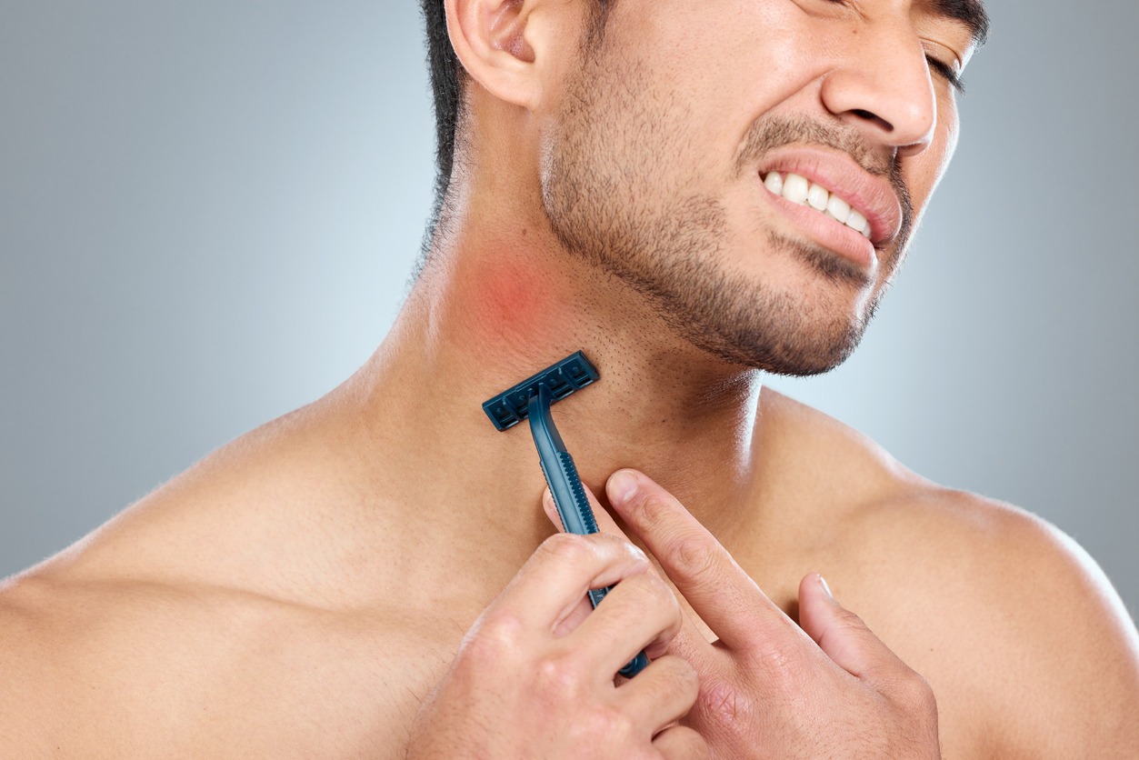 Shot of a man getting razor burn from shaving with a disposable razor