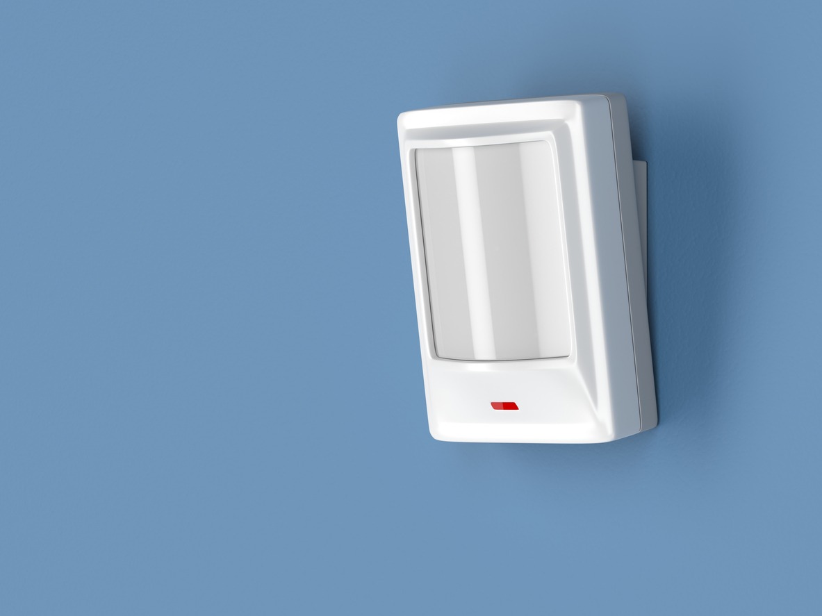 motion sensor installed on a blue wall