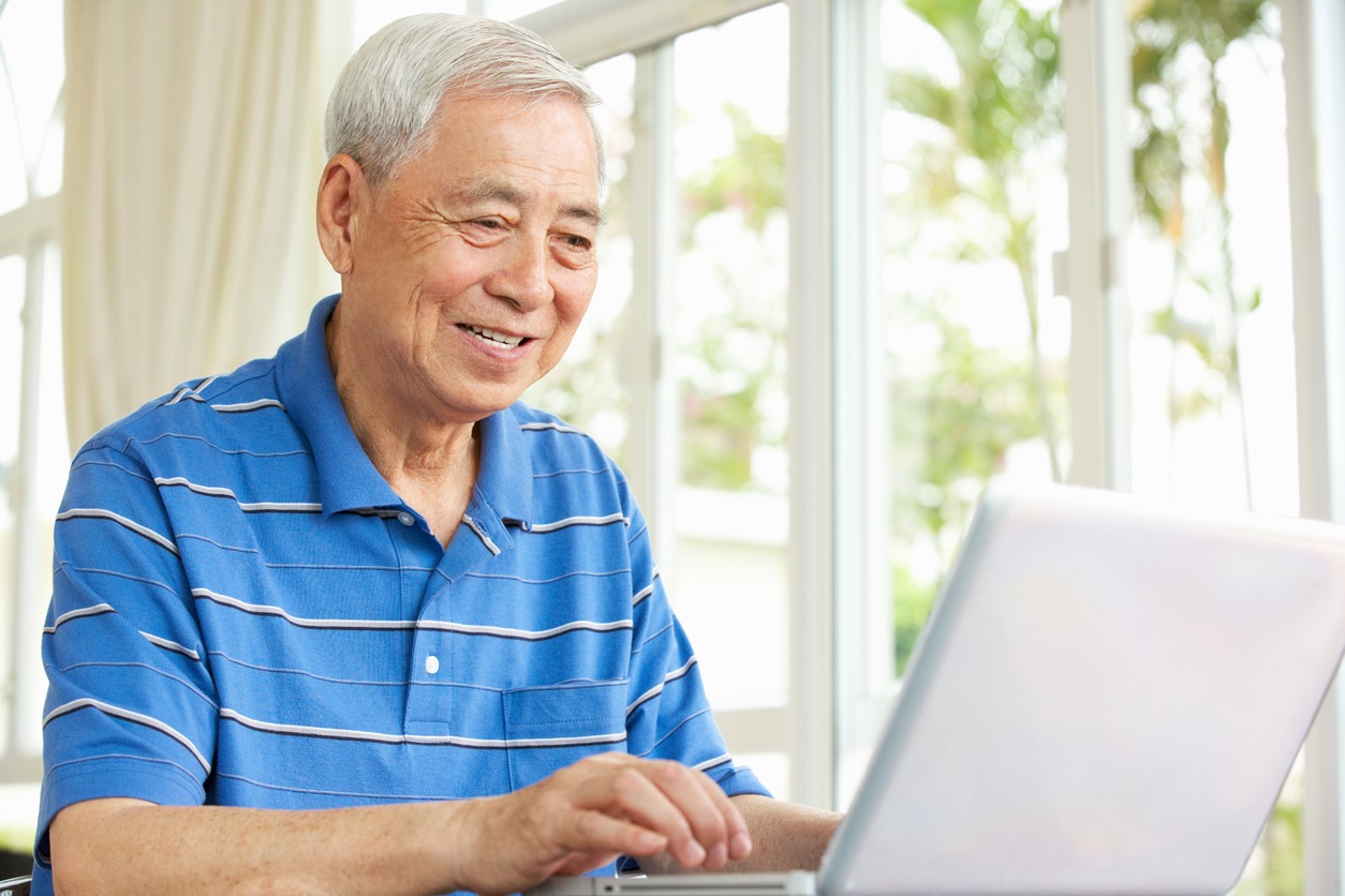 a senior man using a laptop