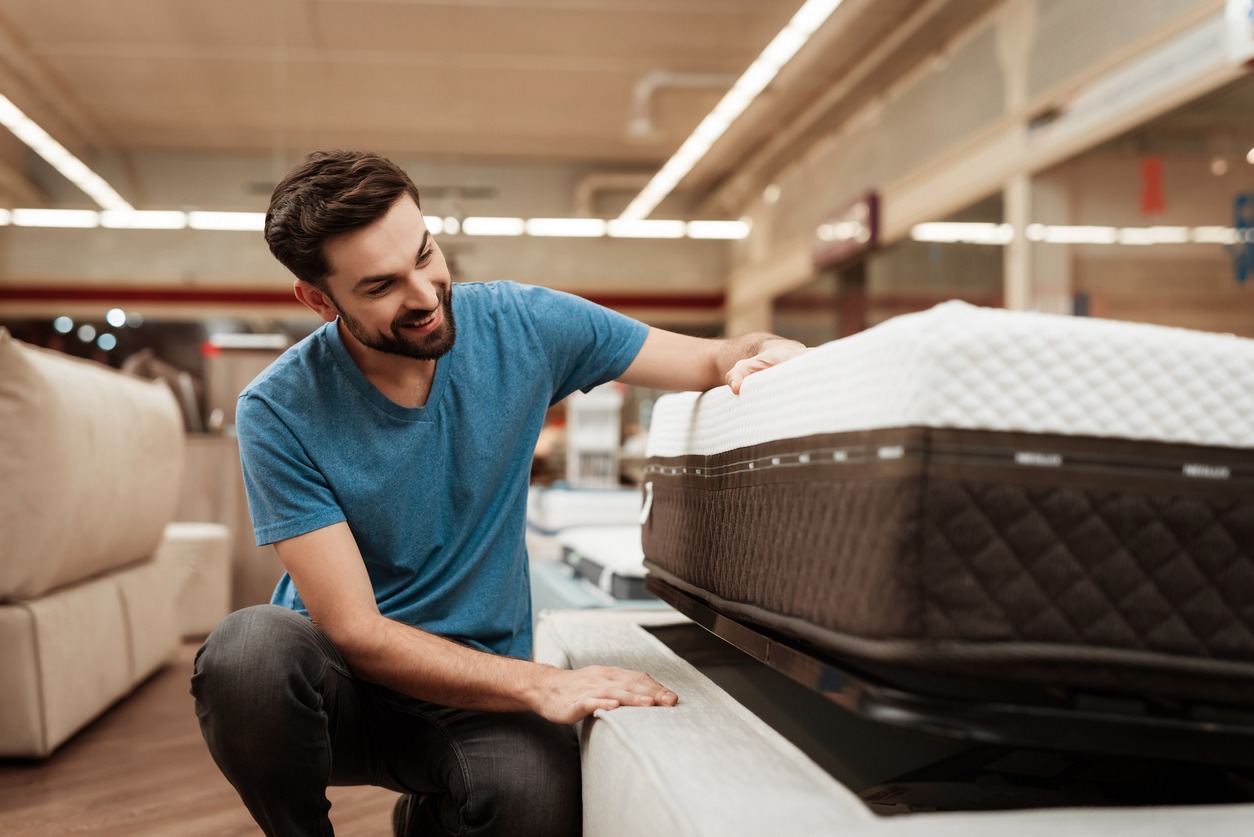 man choosing a mattress in the store