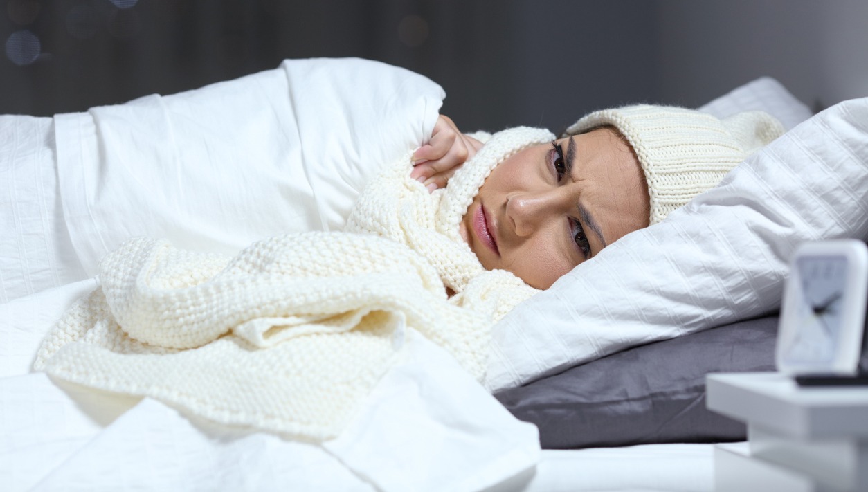 woman feeling cold in bed