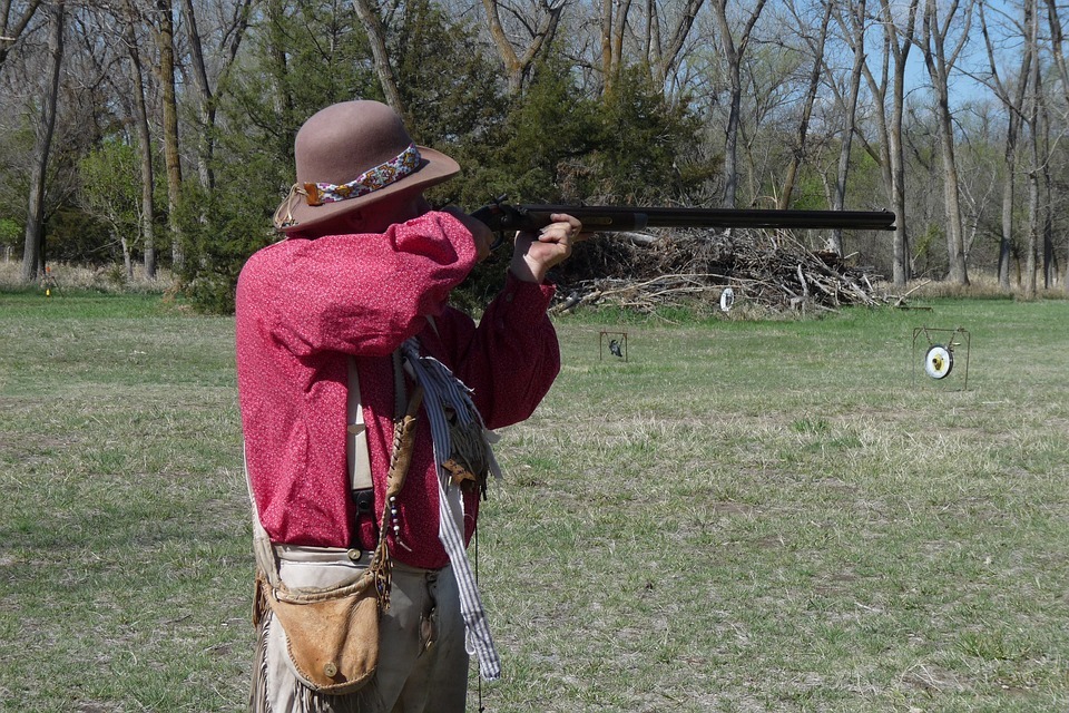 a senior individual preparing to shoot with rifle