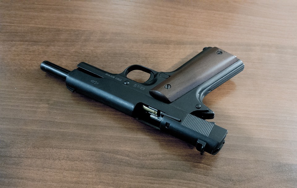 loaded handgun lying on a table 