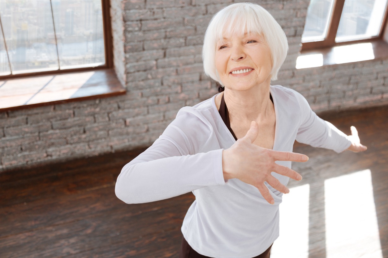 a happy elderly woman dancing