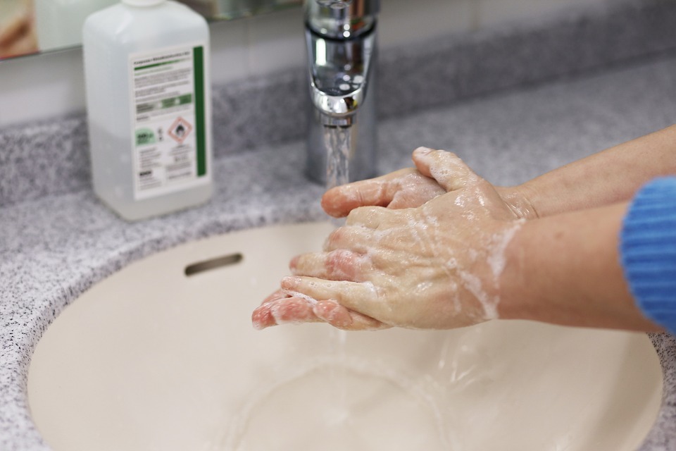 a person washing hand with an anti-bacterial soap
