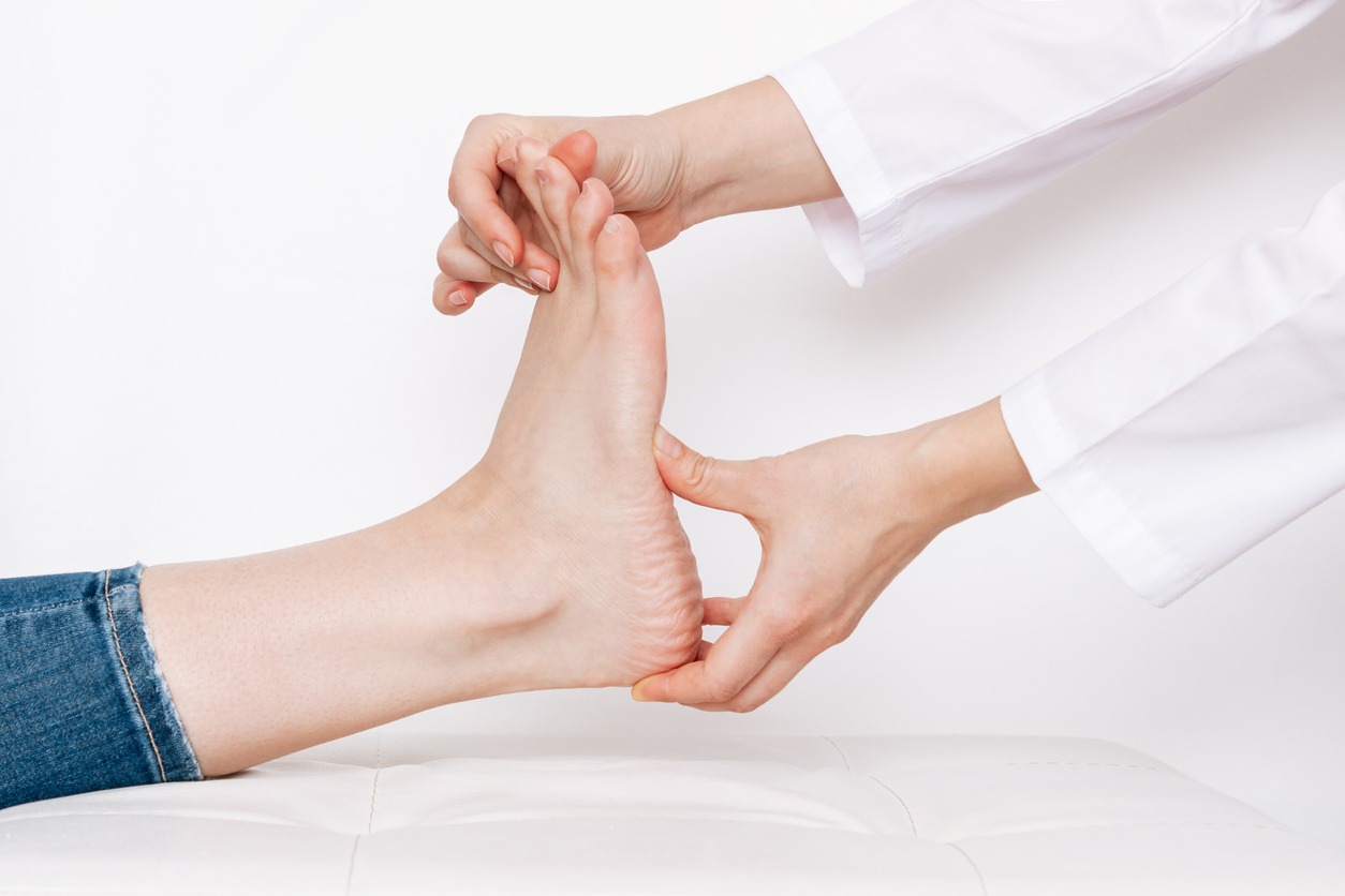 doctor examining the foot of a patient