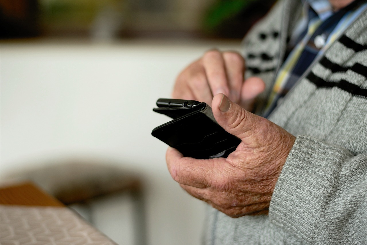 elderly individual using a smartphone