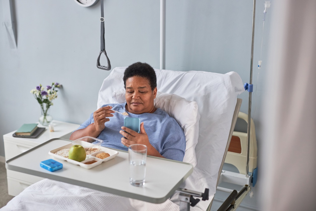 patient using an overbed table while eating