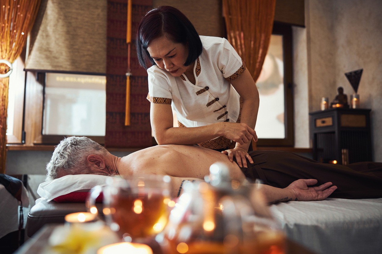 woman giving a traditional massage to a man