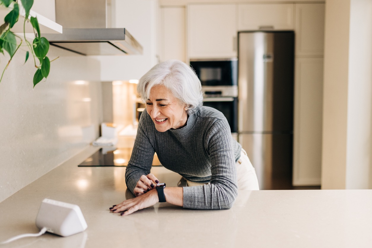 senior woman using a smart device in the kitchen